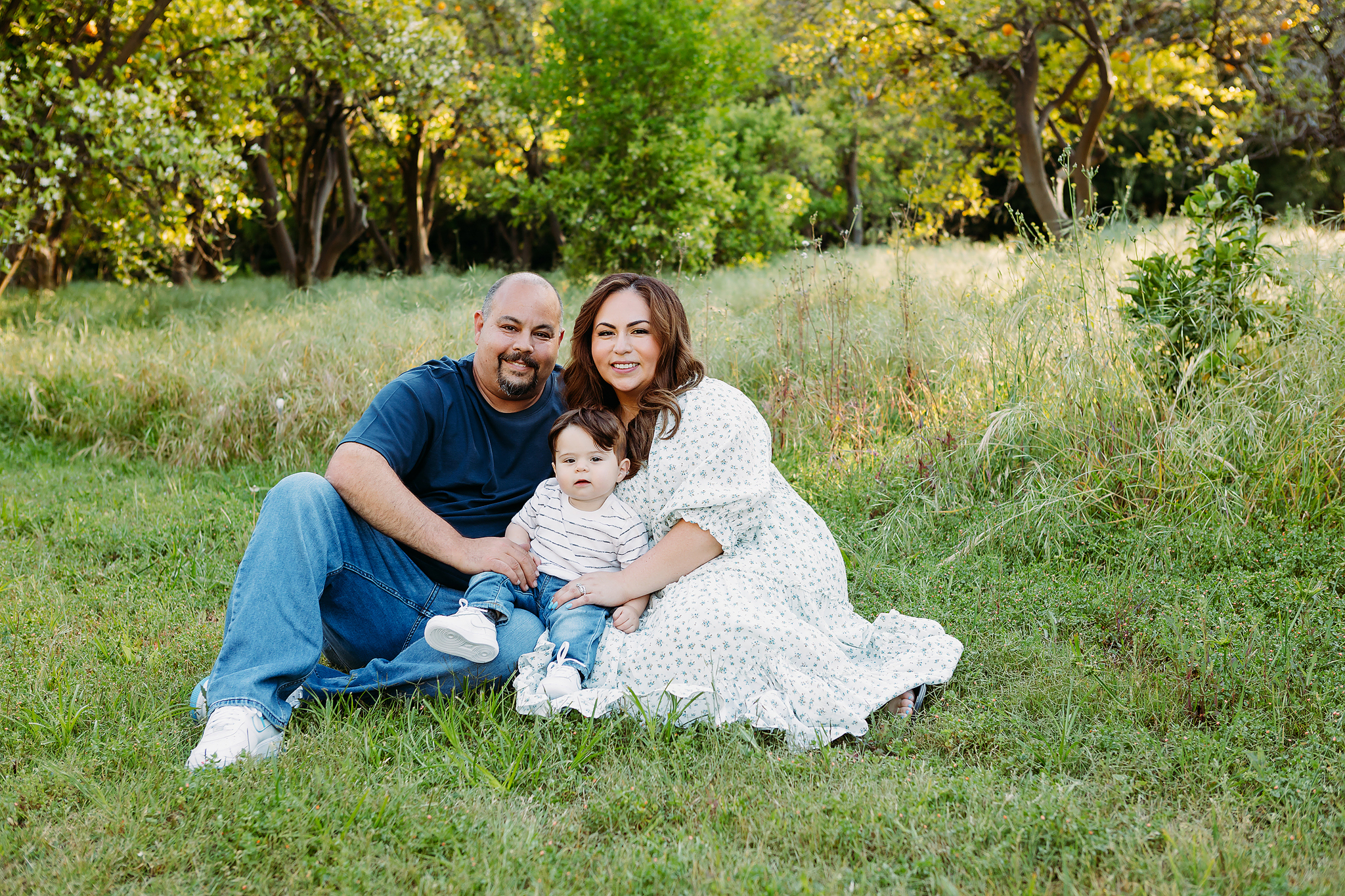 family one-year-old baby during outdoor milestone session with soft natural lighting